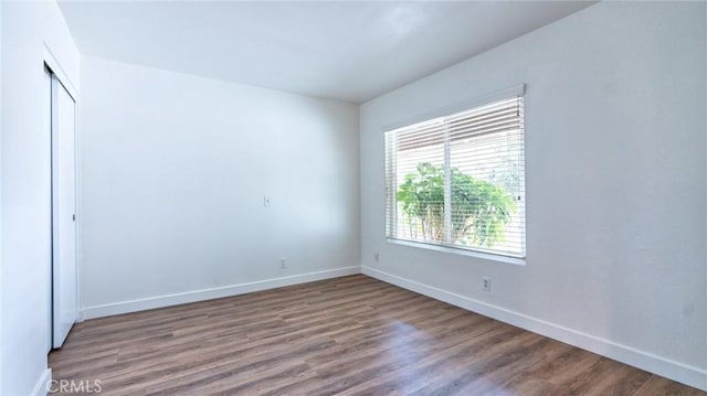 unfurnished bedroom featuring a closet and wood-type flooring