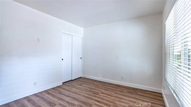 empty room with dark hardwood / wood-style floors