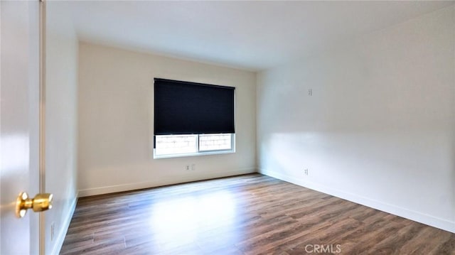 spare room with hardwood / wood-style floors