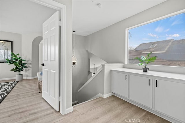 stairway with hardwood / wood-style floors