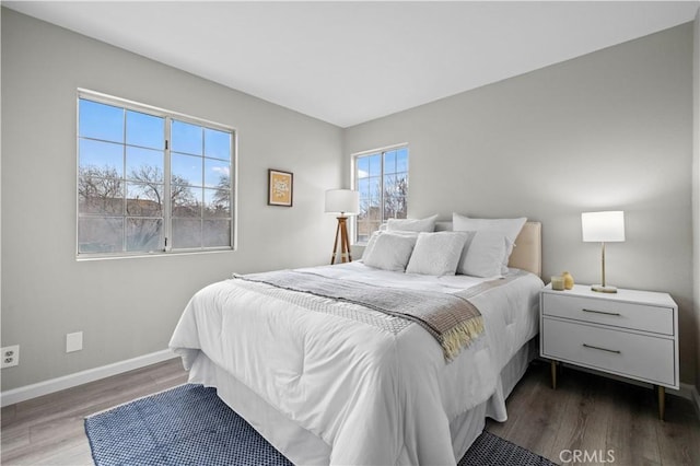 bedroom with dark wood-type flooring