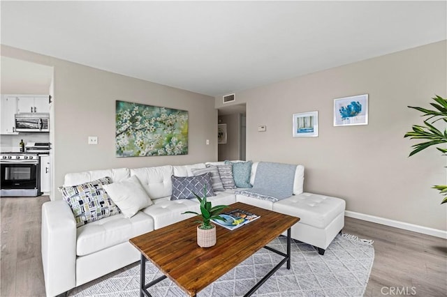 living room with light hardwood / wood-style flooring