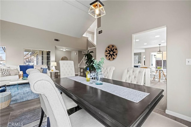 dining space with vaulted ceiling and light hardwood / wood-style floors