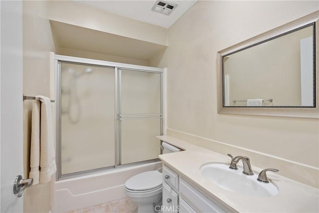 full bathroom featuring tile patterned floors, shower / bath combination with glass door, vanity, and toilet