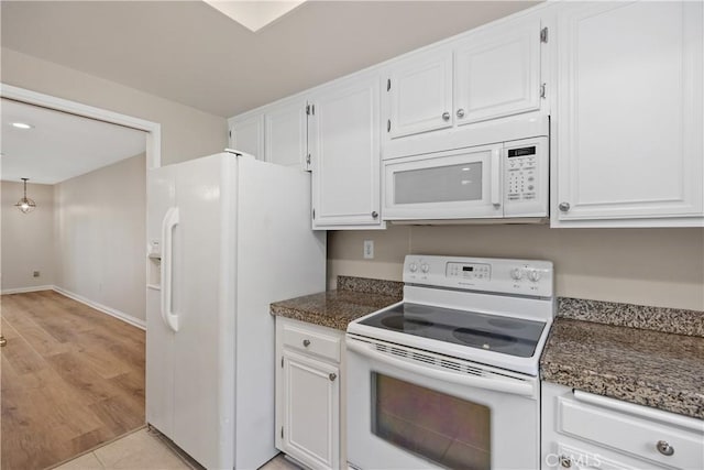 kitchen featuring white appliances and white cabinets