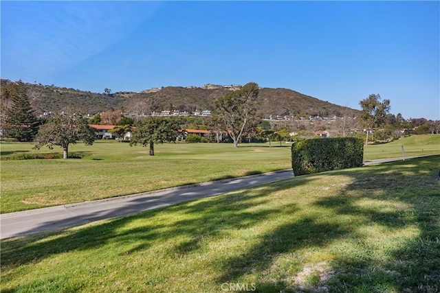 view of property's community featuring a mountain view and a lawn