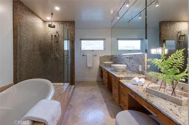 bathroom featuring plus walk in shower and vanity