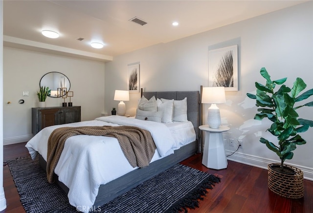 bedroom with dark hardwood / wood-style flooring