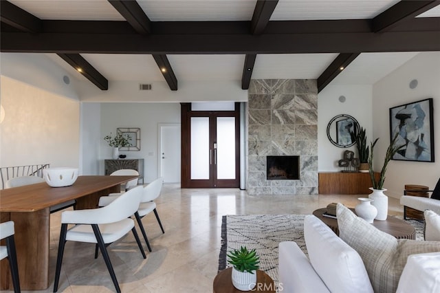 living room with beam ceiling, a premium fireplace, and french doors