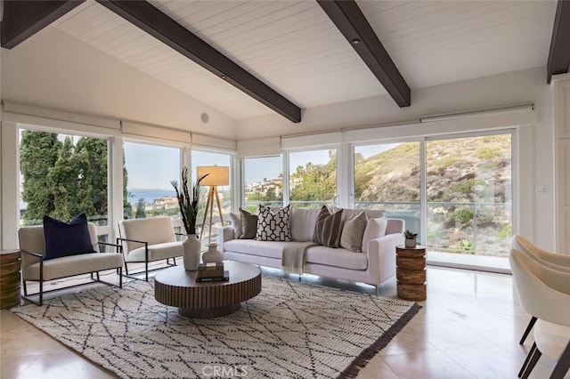 sunroom featuring lofted ceiling with beams