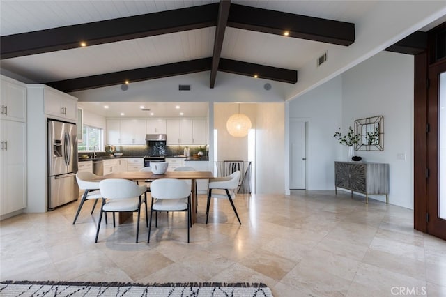 dining area featuring vaulted ceiling with beams, sink, and wood ceiling