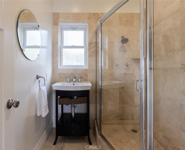 bathroom featuring sink, an enclosed shower, and tile patterned floors