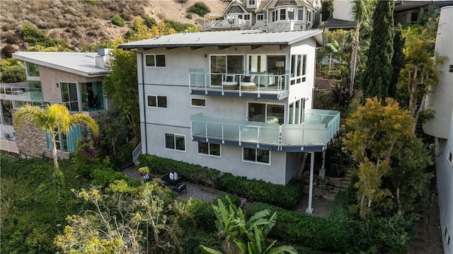 rear view of property featuring a balcony