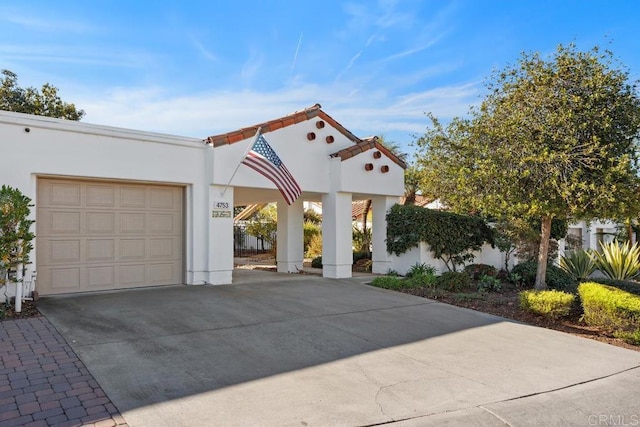 mediterranean / spanish-style home featuring a garage and a carport