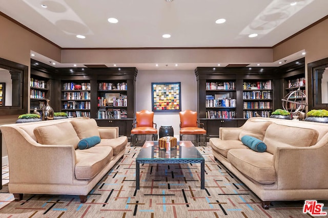 sitting room featuring crown molding and built in shelves