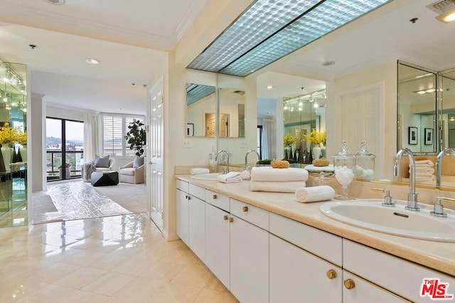 bathroom featuring vanity, tile patterned floors, and ornamental molding