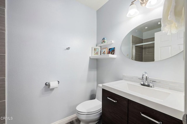 bathroom with vanity, toilet, and walk in shower