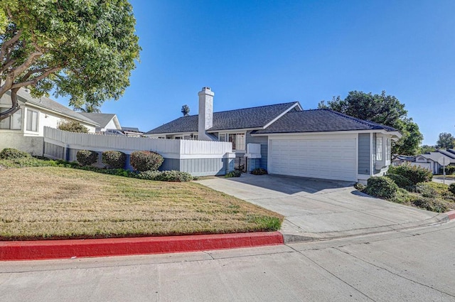 single story home with a garage and a front lawn