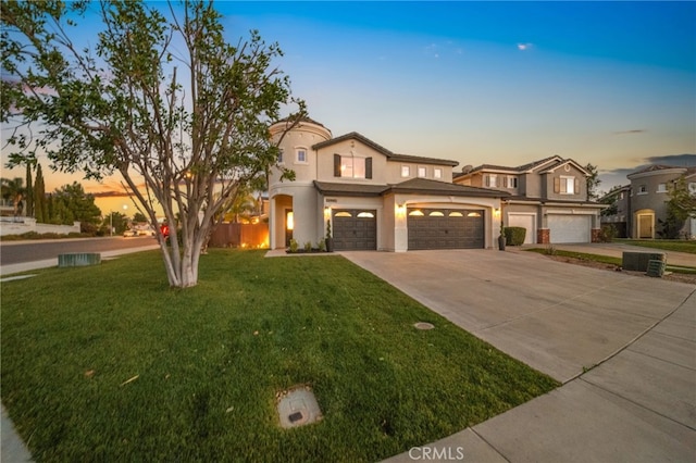 view of front of house with a yard and a garage