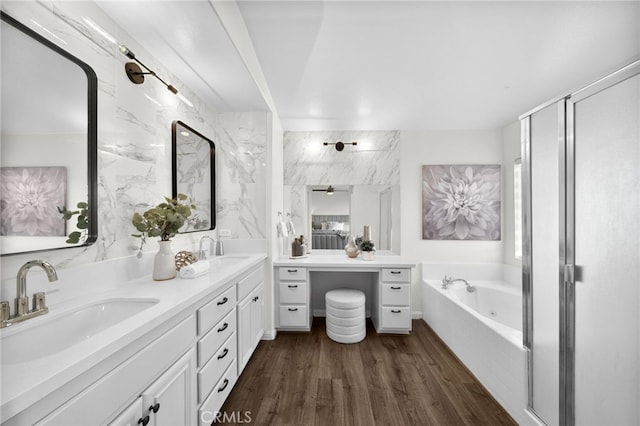 bathroom featuring wood-type flooring, separate shower and tub, and vanity