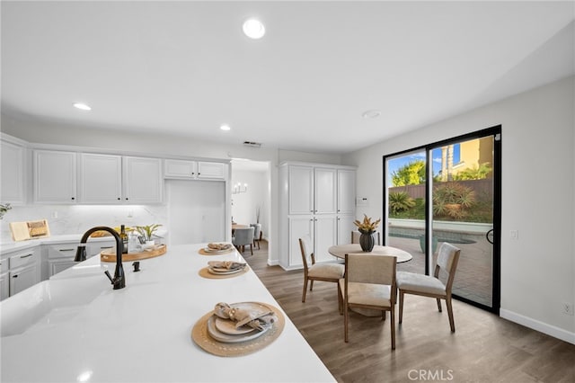 kitchen featuring white cabinetry, tasteful backsplash, and dark hardwood / wood-style floors