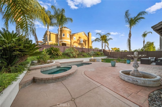 view of pool with a patio area and an in ground hot tub