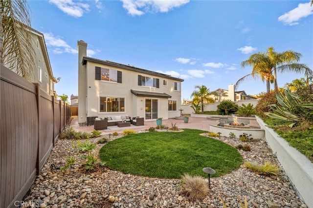 back of property featuring an outdoor living space, a yard, and a patio area