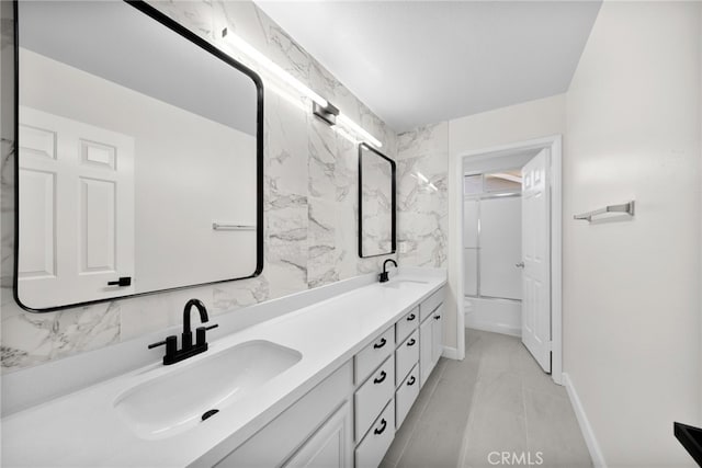 bathroom featuring vanity and shower / bath combination with glass door