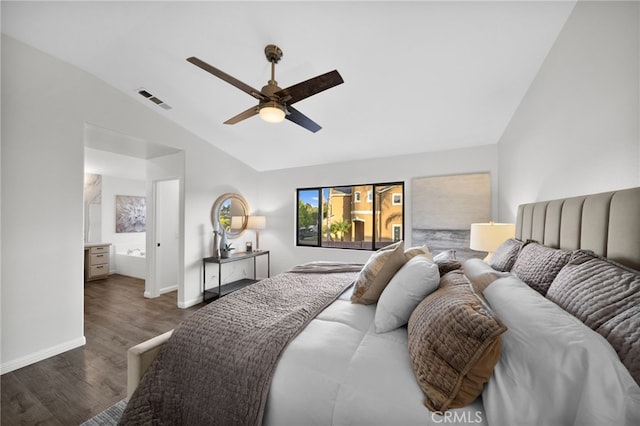 bedroom with ceiling fan, dark hardwood / wood-style flooring, vaulted ceiling, and ensuite bath