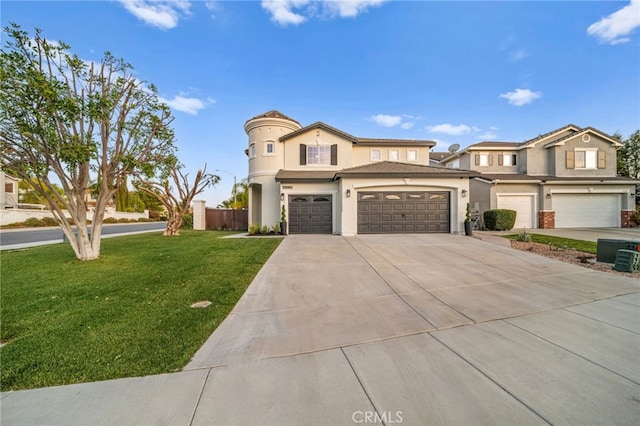 view of front of property with a garage, central AC unit, and a front yard