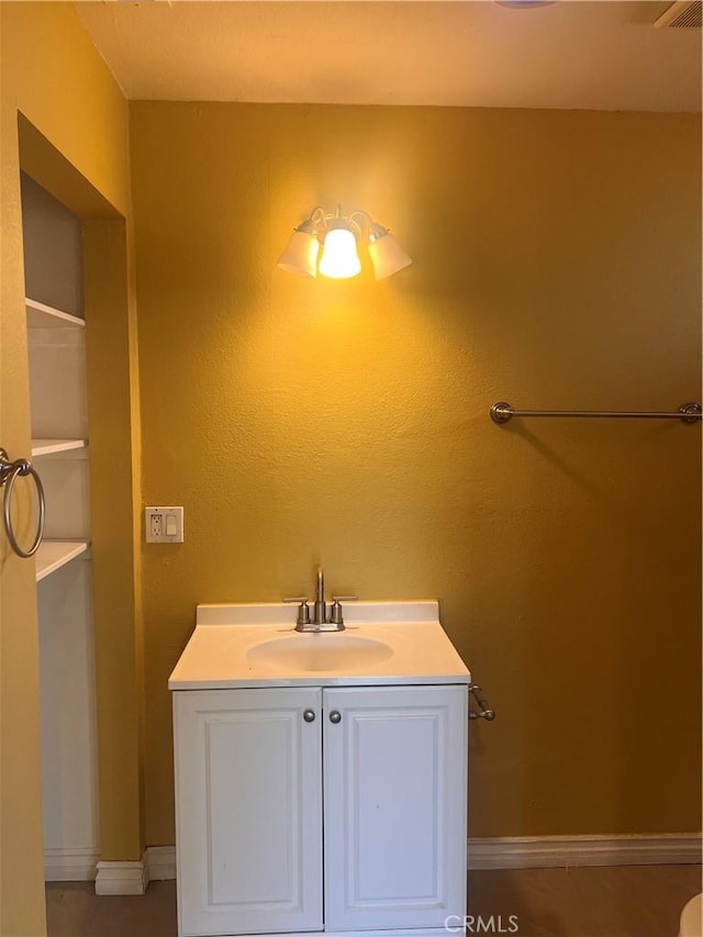 bathroom with vanity and baseboards