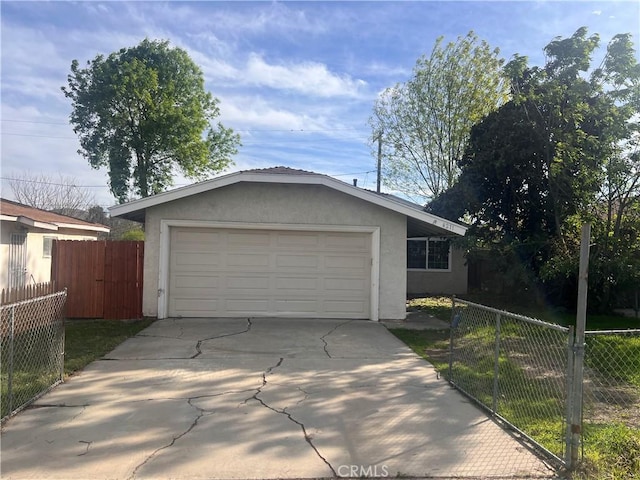 exterior space featuring fence and concrete driveway