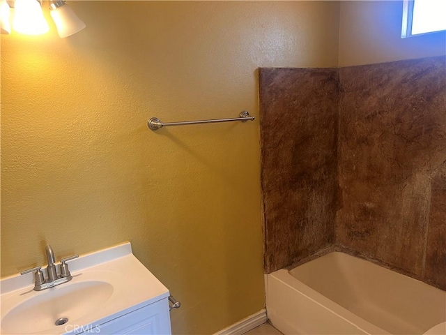 bathroom with shower / tub combination, baseboards, and vanity