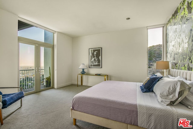 bedroom featuring expansive windows, access to exterior, and french doors