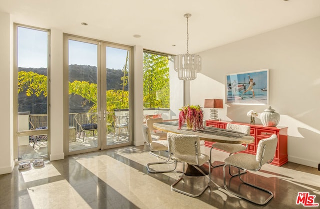 dining room featuring a wall of windows, french doors, and a notable chandelier