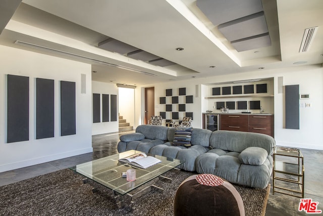 living room with beverage cooler and a tray ceiling