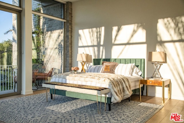 bedroom featuring hardwood / wood-style flooring and access to outside