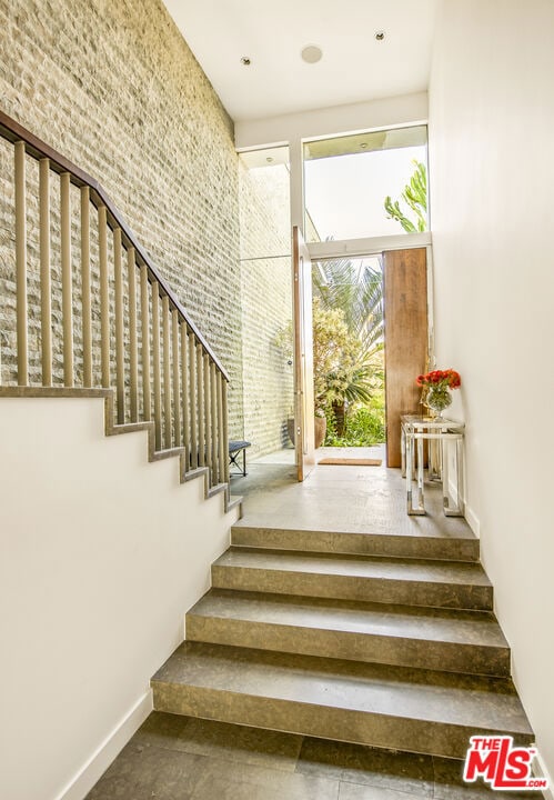 staircase featuring a high ceiling