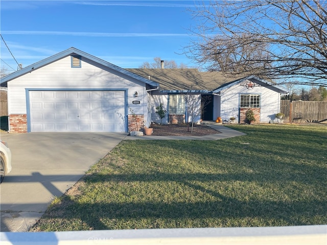 ranch-style home featuring a garage and a front lawn