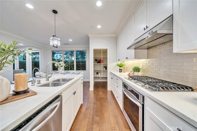 kitchen with sink, stainless steel appliances, light stone countertops, decorative backsplash, and exhaust hood