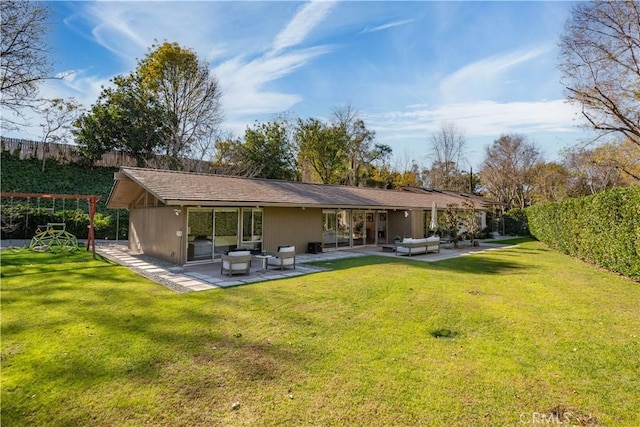 back of property with a patio, a lawn, and outdoor lounge area