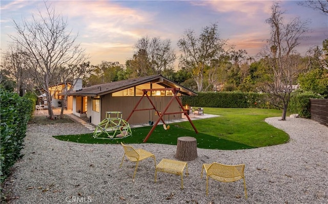 yard at dusk featuring a patio