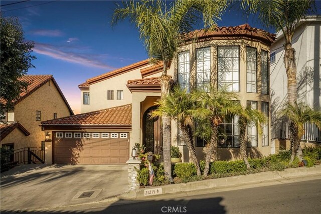 mediterranean / spanish house with a garage