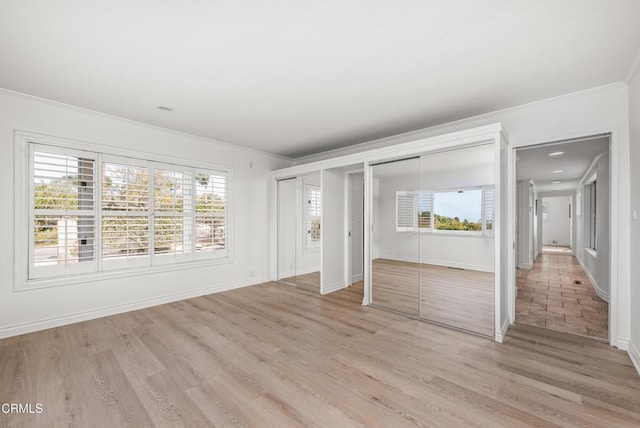 unfurnished bedroom featuring light hardwood / wood-style flooring and ornamental molding