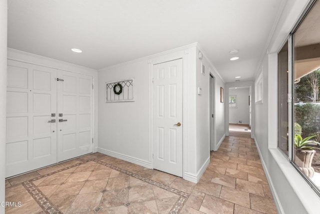 foyer entrance featuring crown molding