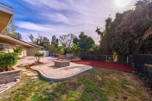 view of yard featuring a fire pit and a patio