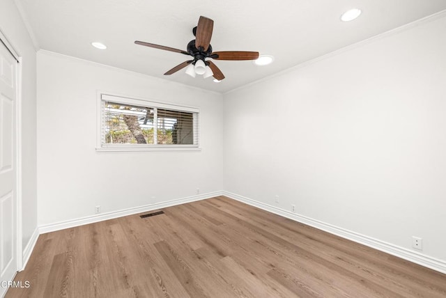 spare room with ceiling fan, crown molding, and light hardwood / wood-style floors