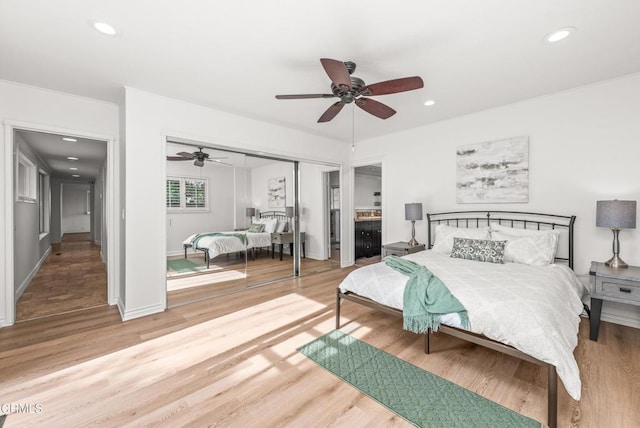 bedroom with ceiling fan, hardwood / wood-style floors, and a closet