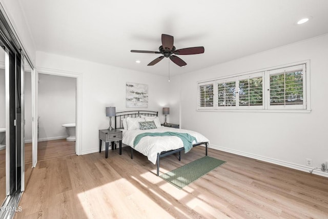 bedroom with ceiling fan, light hardwood / wood-style floors, and ensuite bathroom