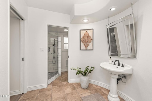 full bath with stone finish floor, recessed lighting, a shower stall, and baseboards